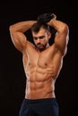 Strong man making exercises on triceps with a dumbbell. Close up shot training hands. Fitness Model showing his Torso Royalty Free Stock Photo