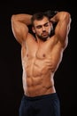 Strong man making exercises on triceps with a dumbbell. Close up shot training hands. Fitness Model showing his Torso Royalty Free Stock Photo