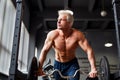 Strong man with muscular body working out in gym. Weight exercise with barbell in fitness club. Royalty Free Stock Photo