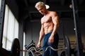 Strong man with muscular body working out in gym. Weight exercise with barbell in fitness club. Royalty Free Stock Photo