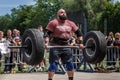 Strong man raises a heavy barbell. Weightlifting Royalty Free Stock Photo