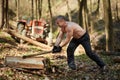 Strong man splitting logs