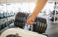 Strong man taking dumbbell in the gym Royalty Free Stock Photo