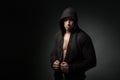 Strong man wearing hoodie isolated on black background Royalty Free Stock Photo