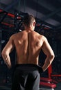 Strong masculine man athlete doing standing in dark fitness club background. Closeup portrait Royalty Free Stock Photo