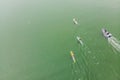 Strong men floating on a SUP boards in a beautiful bay on a sunny day. Aerial view of the men crosses the bay using the Royalty Free Stock Photo