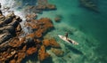 Strong men floating on a SUP boards in a beautiful bay on a sunny day. Aerial view of the men crosses the bay using the Royalty Free Stock Photo