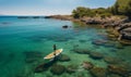 Strong men floating on a SUP boards in a beautiful bay on a sunny day. Aerial view of the men crosses the bay using the Royalty Free Stock Photo