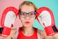 Strong mentally and physically. Smart and strong. Woman boxing gloves adjust eyeglasses. Win with strength or intellect