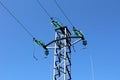 Strong metal power line connected with multiple wires and glass insulators on one side and cut wires on other surrounded with