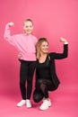 strong mother and daughter showing muscular biceps