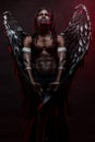 Strong muscular angel with black wings