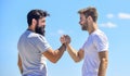 Strong and muscular arms. Successful deal handshake blue sky background. Men shaking hands at meeting. Friendly