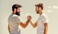 Strong and muscular arms. Successful deal handshake blue sky background. Men shaking hands at meeting. Friendly Royalty Free Stock Photo