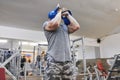 Strong muscular athlete man exercising with kettlebells in gym, weight training Royalty Free Stock Photo