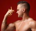 Strong muscular athlete men hold in hand french fries unhealthy junk fast food