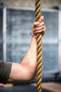 Strong muscular male arm holding a rope Royalty Free Stock Photo