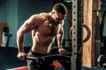 Strong muscular man doing push-ups on uneven bars in crossfit gym Royalty Free Stock Photo