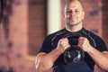 Strong muscular man exercising with kettlebell facilities in gym Royalty Free Stock Photo