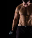 Strong muscular man holding dumbbell on black Royalty Free Stock Photo