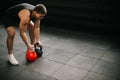 Strong muscular man with perfect beautiful body wearing sportswear lifting heavy free weights Royalty Free Stock Photo