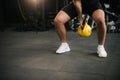 Strong muscular man with perfect beautiful body wearing sportswear lifting heavy free weights Royalty Free Stock Photo