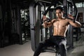 Strong muscular man preparing for workout in crossfit gym. Young athlete practicing cross-fit training Royalty Free Stock Photo
