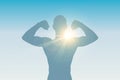 Strong muscular man silhouette on sunny background