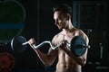 Strong Muscular man working out in gym doing exercises with barbell at biceps Royalty Free Stock Photo