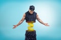 Strong muscular young man cut in half with yellow measuring tape inside on blue background