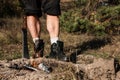 Strong musculine legs of a man, staning in half turn behind fire. Royalty Free Stock Photo