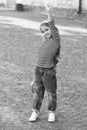 Strong performance. Proud skater hold up hand with clenched fist. Small girl with penny board outdoors. Power slide Royalty Free Stock Photo