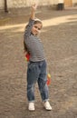 Strong performance. Proud skater hold up hand with clenched fist. Small girl with penny board outdoors. Power slide Royalty Free Stock Photo