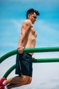 Caucasian fitness male exercising outdoors on metal bars Royalty Free Stock Photo