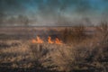 Strong prairie fire with large clouds of choking smoke erupted in southern steppe. Royalty Free Stock Photo