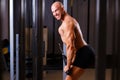 Strong ripped bald man pumping iron. Sports man bodybuilder smil