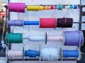 Strong ropes of different colors are wound on special reels bobbins of colored rope in store