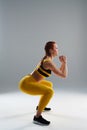 Strong rude woman doing squats Royalty Free Stock Photo