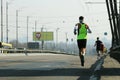 Strong runners running on city bridge road. Running on city bridge. Marathon running in the morning. Athletes runner feet running