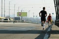 Strong runners running on city bridge road. Running on city road. Marathon running in the morning. Athletes runner feet running.