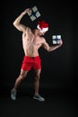 Strong Santa. Muscular man wear santa claus hat. Bodybuilder on black background. Winter holidays. Muscular sportsman Royalty Free Stock Photo