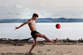 Strong male kick red ball Royalty Free Stock Photo