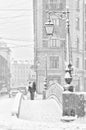 The strong snowstorm in Saint Petersburg. People walking along Demidov bridge.