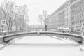 The strong snowstorm in Saint Petersburg. People walking along Sennoy bridge.