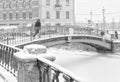 The strong snowstorm in Saint Petersburg. People walking along Sennoy bridge.