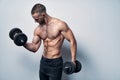 Strong sport sirtless man making weightlifting with dumbbells