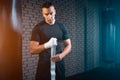 Athletic boxer man bandage hand and preparing for training or fighting in gym