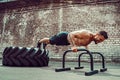 Strong sporty happy cheerful positive man doing press exercises holding plank outdoors Royalty Free Stock Photo