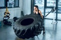 strong sporty woman flipping workout wheel