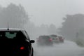 The strong storm with heavy rain on the road with poor visibility of cars